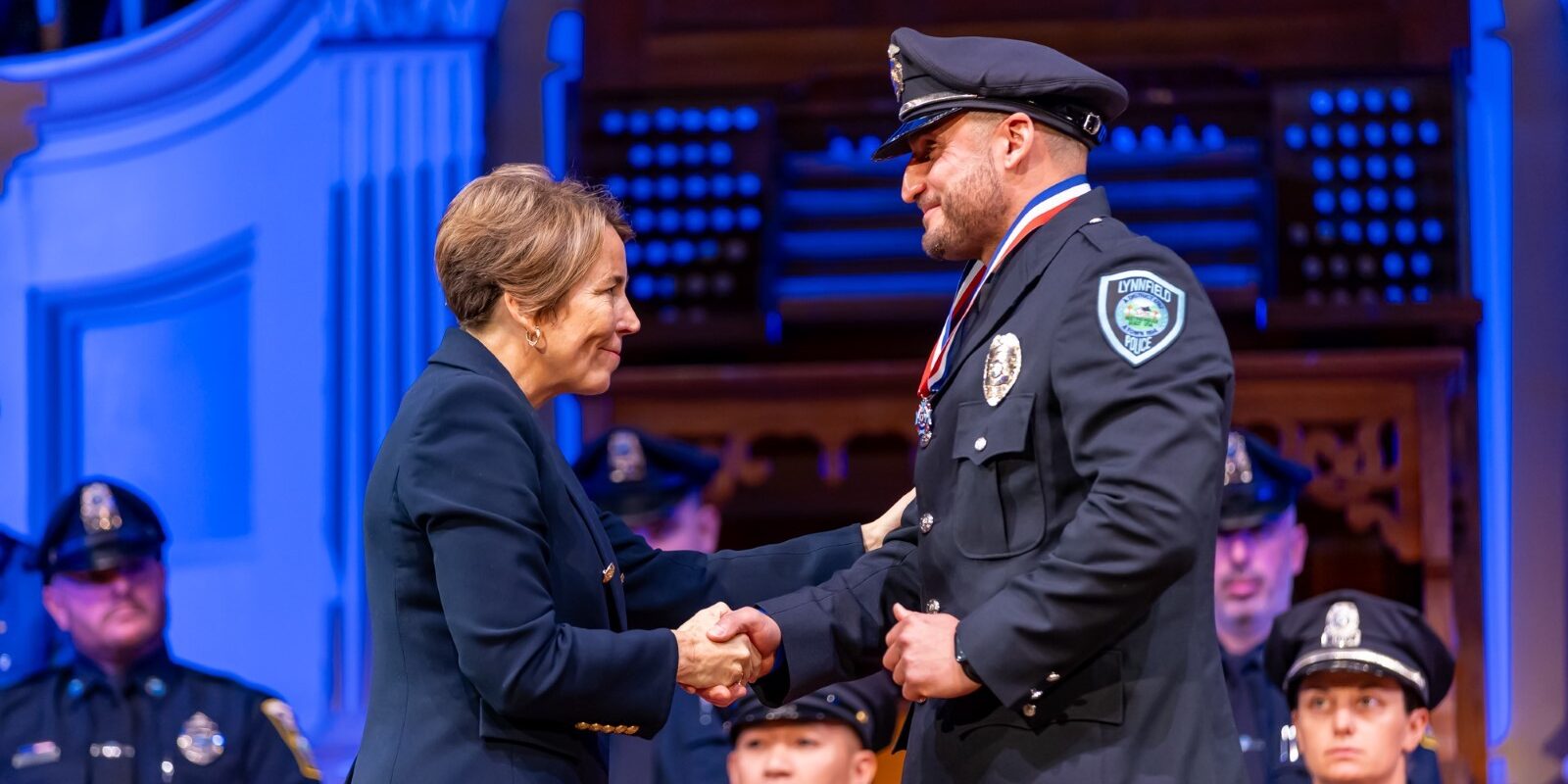 Governor Healey shakes hands with Medal of Valor recipient Gianfranco M. Pisano